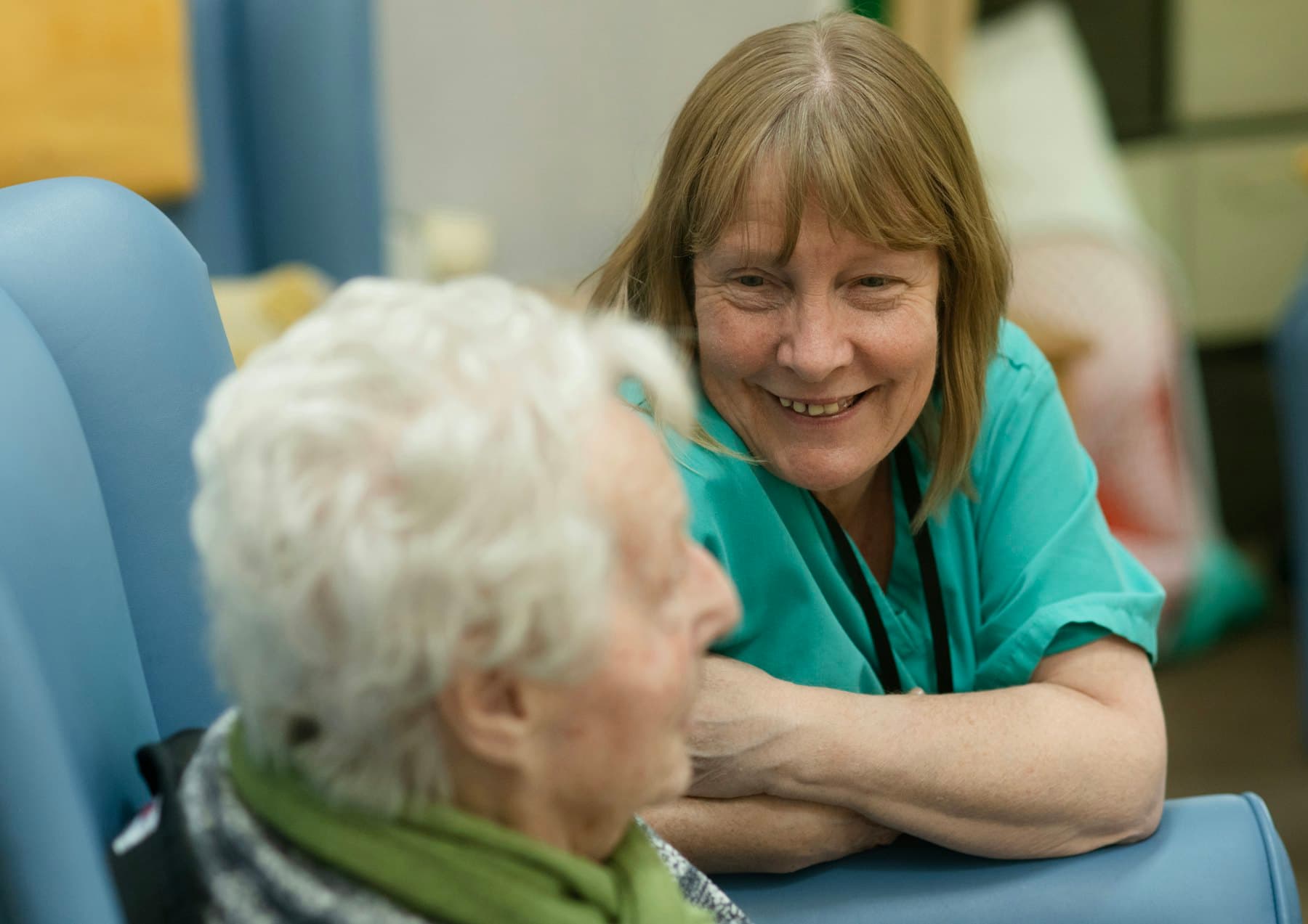 A caregiver sharing a warm smile with a resident